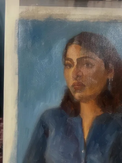 A side view of the finished portrait of Mirra, showing the texture of the oil on linen.