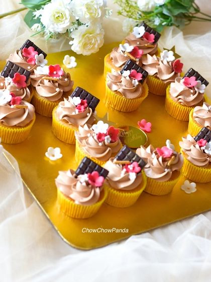 Another perspective of the choco-vanilla cupcake set, showing how they are arranged on a golden tray for presentation.