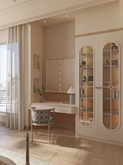 A closer look at the custom vanity and display unit, featuring arched glass doors that reflect the room's recurring design motif. The soft color palette ensures the furniture feels integrated and elegant.
