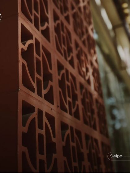 A close-up of the intricately patterned terracotta jali blocks used for ventilation and as a decorative screen.