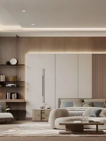 This spacious and serene bedroom features a neutral color palette with wood and white finishes. The design includes a comfortable seating area, creating a private retreat for relaxation within the master suite.