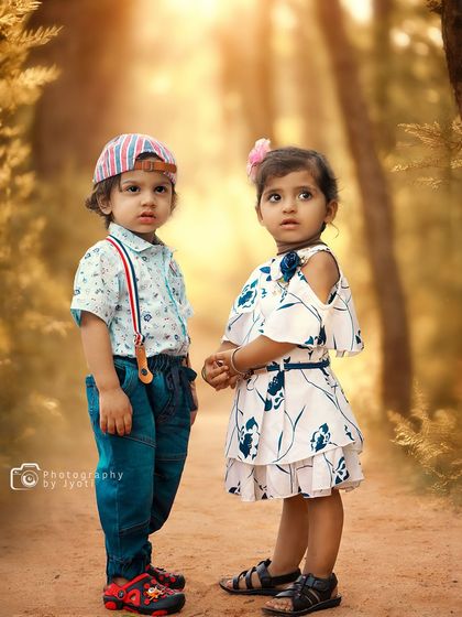 A full-length portrait of a brother and sister standing together on a path during their outdoor photoshoot. I capture both individual and group shots to tell the full story.
