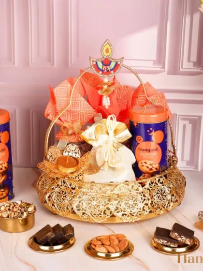 Celebrate health and luxury with the Abhushan Hamper. This golden basket is filled with cookies, nuts, and sugar-free bars, complete with a 'Shubh Labh' diya for a thoughtful festive touch.