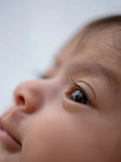 A close-up of a newborn's eye, capturing the depth and wonder in their gaze even in their first few days of life.