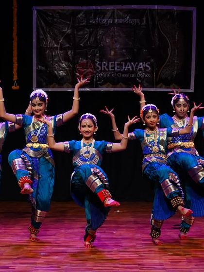 The power and precision of the Kalakshetra style, demonstrated beautifully by this group of dancers. Their coordinated leaps show excellent form and training.