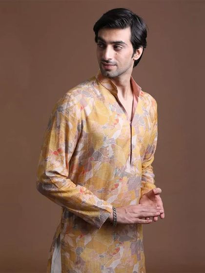 A closer look at the abstract printed yellow kurta. The unique design and color palette make it a standout piece for any celebration.