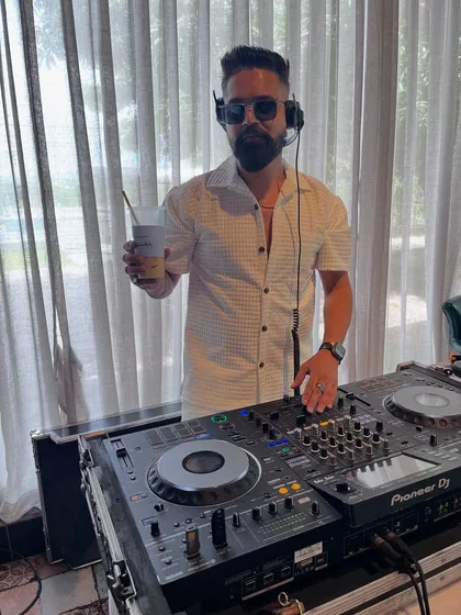 Coffee in hand, ready to drop some beats. A shot of me at the console during a daytime event, keeping the energy flowing.