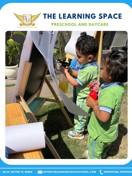 Outdoor color play for Holi. Children use spray bottles to create art, a fun gross motor activity that brings the festive spirit outdoors.