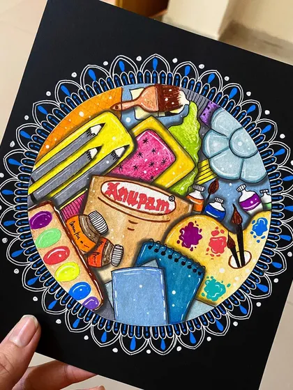 A tribute to my favorite art supplies! This piece is a colorful doodle of stationery items like paints, brushes, and sketchbooks, all framed within a blue and white mandala border.