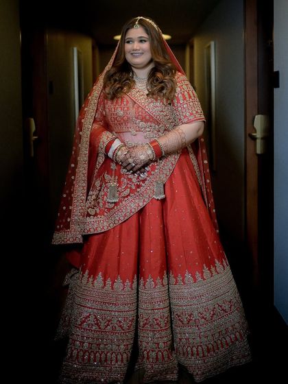 A full-length shot in a hallway, showing how the entire look comes together. The draping and makeup are done to perfection.
