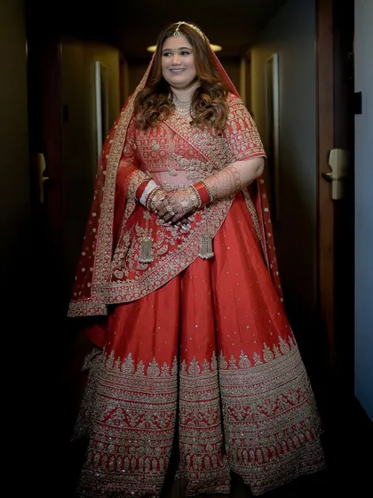A full-length shot in a hallway, showing how the entire look comes together. The draping and makeup are done to perfection.