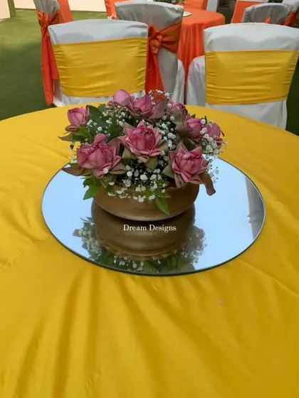 A cheerful yellow tablecloth sets the stage for a lotus centerpiece. I use bold, solid colors in my Mehndi designs to create a vibrant and energetic atmosphere.