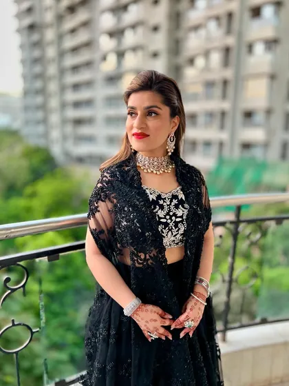 The soft waves and elegant half-up style create a look that is both modern and timeless. This is a great example of a polished party hairstyle.
