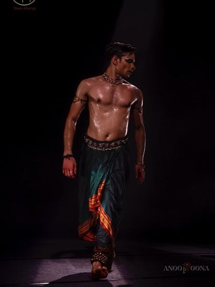 A shot of me from 'Nagamandala' at the Aharya Dance Festival, captured mid-stride with intense focus.