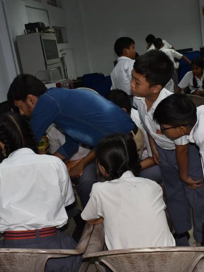 Students at a school in Guwahati gather around a computer, working as a team to program their robot. Our curriculum emphasizes both building and coding.