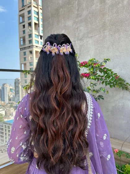 The back view of this beautiful hairstyle, showcasing the full length of the waves and the pretty butterfly hair accessories.