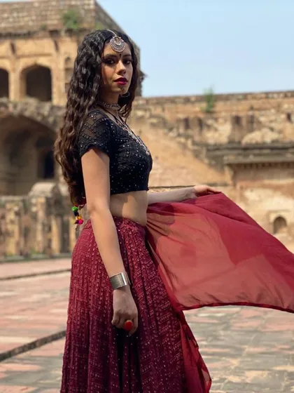 This is from the music video for 'Jogan', where I designed a dark, moody boho look. I paired a black sequined blouse with a deep red lehenga and layered oxidized silver jewellery to create a powerful and mystical character. This kind of detailed character styling is a key part of my process.