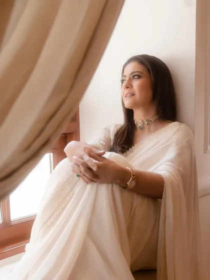 Lost in thought, this image captures the dreamy and romantic feel of the white chiffon saree, paired with a statement choker.