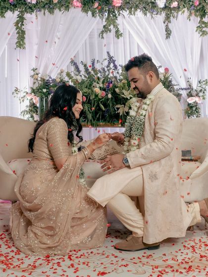 A repeat of the romantic proposal during the engagement ceremony, a classic and essential shot for any wedding album.