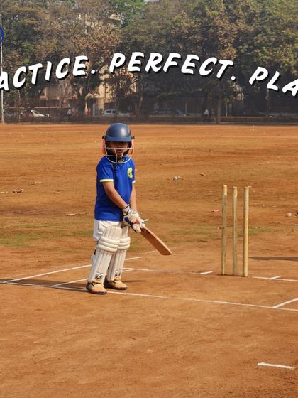 Practice. Perfect. Play. A young, fully-padded cricketer stands ready at the stumps, embodying the focus and determination we nurture in our academy from the earliest age.