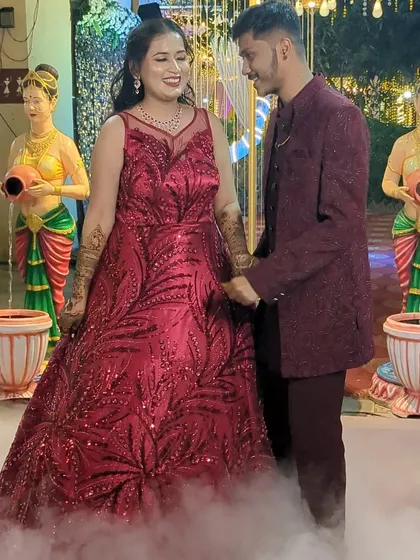 Make a grand entrance at your engagement party with this stunning red sequin gown. We can coordinate it with a matching Jodhpuri suit for the groom-to-be.