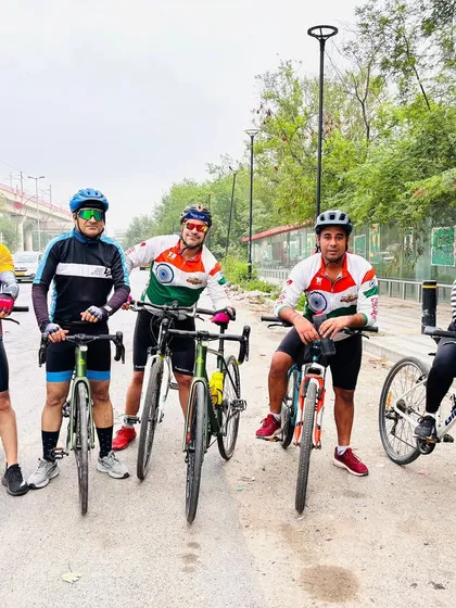A group of cyclists with their bikes. We are a team, and we ride as one.
