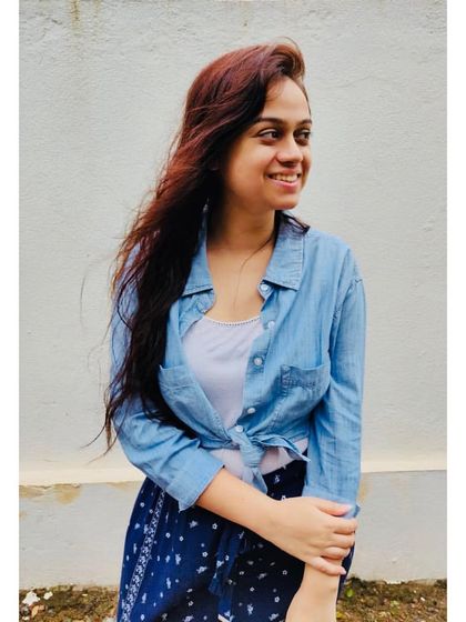 A simple denim shirt layered over a white tank top is a timeless casual look. It's my go-to for a relaxed, feel-good vibe, perfect for a vacation or a weekend at home.