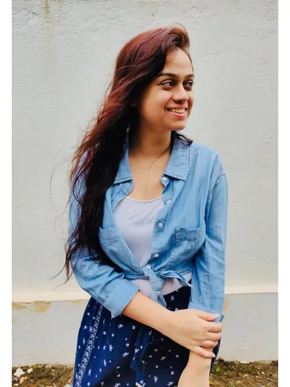 A simple denim shirt layered over a white tank top is a timeless casual look. It's my go-to for a relaxed, feel-good vibe, perfect for a vacation or a weekend at home.