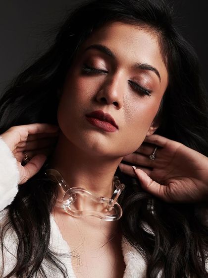 This image captures a moment of quiet confidence, with the hair's texture and movement adding to the artistic feel of the shoot.