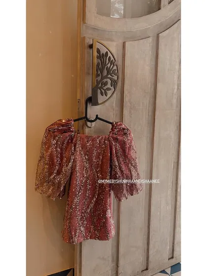 Another look at our sequined party top, this time in a lovely shade of rose gold. The puffy sleeves and all-over shimmer make this a fun and glamorous choice for kids.