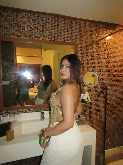 Another angle of the golden sequin top and white pants outfit.