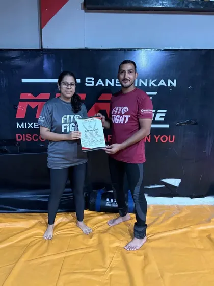 Another student receiving her certificate of participation. Our camps are a challenging but rewarding experience for everyone involved.