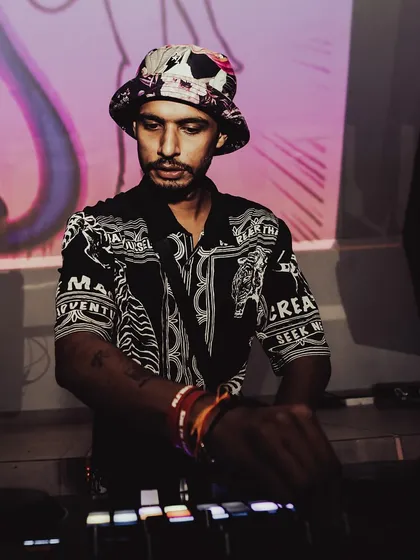 A focused shot of me at the decks, with the 'Salty' visuals projected behind me. Every gig is a chance to create a unique experience.