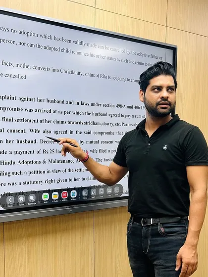 A focused moment during a lecture. I am explaining a complex legal point on the smartboard, ensuring every student can follow the reasoning step by step. My teaching method emphasizes visual aids to simplify difficult topics.