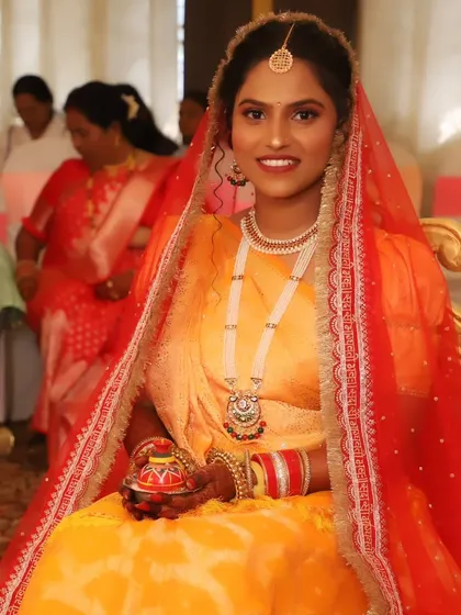 The bride holding a sindoor box, a significant part of the North Indian bridal look.