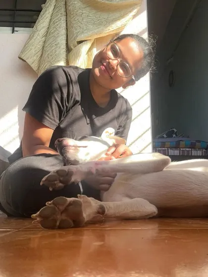 Soaking up the sun with Scooby. This photo shows a beautiful, relaxed moment of me and a dog enjoying the simple pleasure of a sunbeam and a gentle cuddle. This is pure contentment.