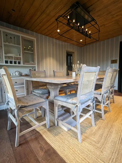 A before shot of the dining room, showing the transformation into a warm and inviting space. The addition of the wood ceiling, new lighting, and curated furniture completely changed the atmosphere.