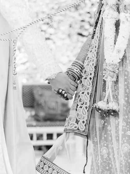 Sometimes, the smallest gestures tell the biggest stories. A simple, timeless black and white shot of hands clasped together symbolizes the promise and the beginning of a shared journey.