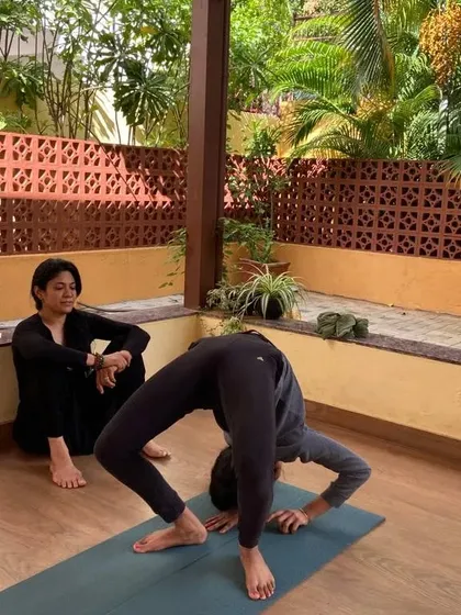 A moment of focused instruction during a workshop for dancers. I am explaining the nuances of a pose to help the students understand their bodies better and push their limits safely.