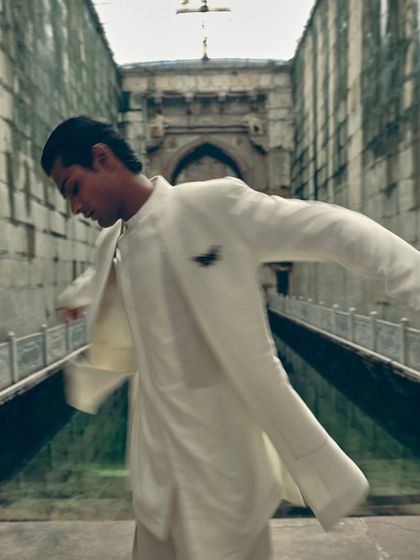 A motion shot that captures the fluid movement of the layered jacket. Even in menswear, I like to show how the garments move and live on the body.