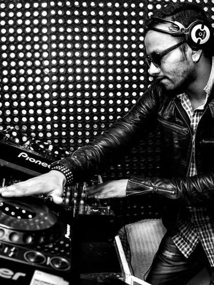 A classic shot of me focused on the mix. This black and white photo captures the concentration and passion that goes into crafting the perfect set on my Pioneer decks.