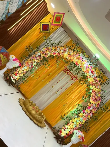 An overhead shot of the Haldi decor, showing the beautiful curve of the floral arch.