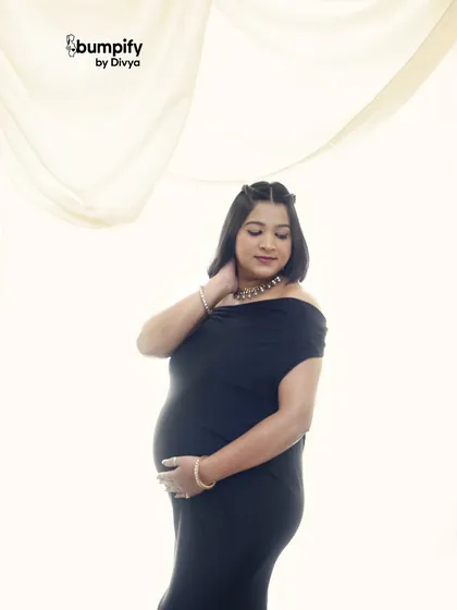 A simple and elegant close-up against a white backdrop. This timeless portrait focuses on the beauty and serenity of the mom-to-be.