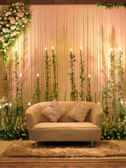 A simple yet elegant stage setup for a Roka or engagement ceremony, with a clean backdrop and floral accents.