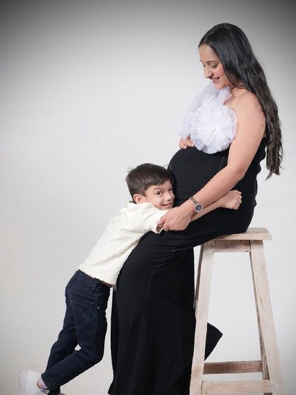 A heartwarming moment between a mother and her son. The Veneccia gown is perfect for family shoots, celebrating the arrival of a new sibling.