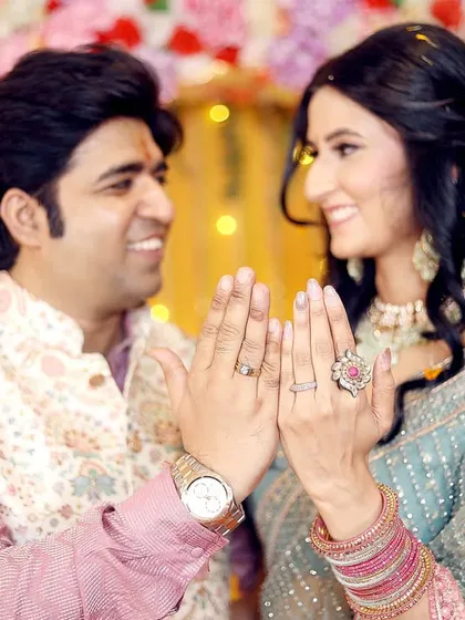 A fun and happy shot of the couple showing off their engagement rings. This pose is full of joy and excitement.