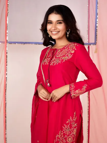 A classic e-commerce portrait with a happy, smiling model. The clean background and bright lighting are perfect for showcasing the details of the red kurta.
