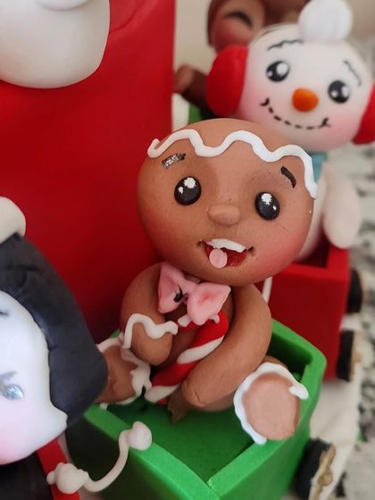 A close-up of the adorable gingerbread man figurine from the Christmas train cake.