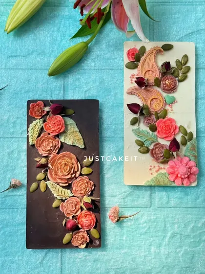 Another look at my hand-painted artisanal chocolate bars, perfect for gifting. The intricate floral details are made from chocolate, making the entire bar a delicious work of art.