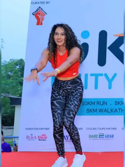 An instructor leads the crowd in a dynamic warm-up. I ensure all pre-race activities are engaging and professionally led to prepare runners for the main event.
